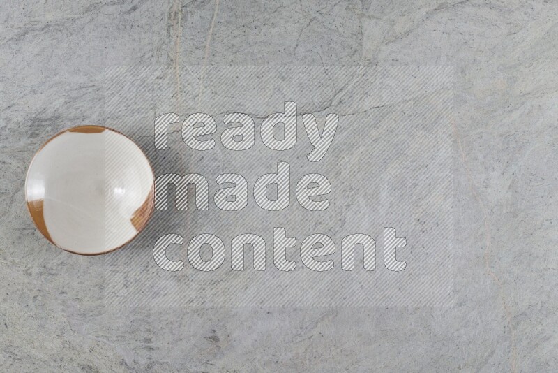 A multicolored pottery plate on grey marble background