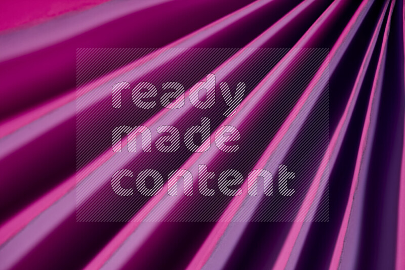 An image presenting an abstract paper pattern of lines in purple tones