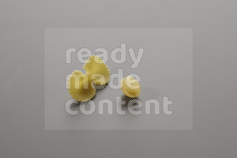 Fiocchi pasta with other types of pasta on grey background