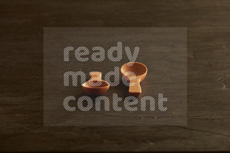 wooden spoon on black slate background