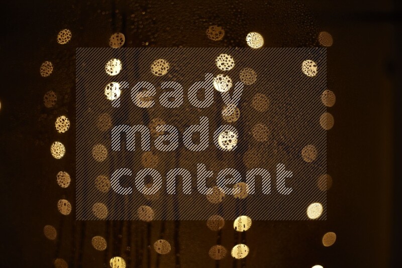 Bokeh light in yellow with water drops