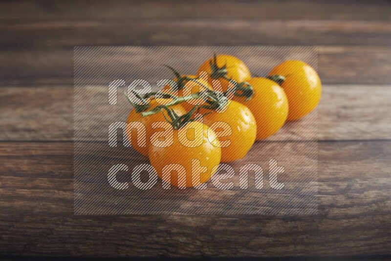 yellow cherry tomato vein on a textured wooden background 45 degree