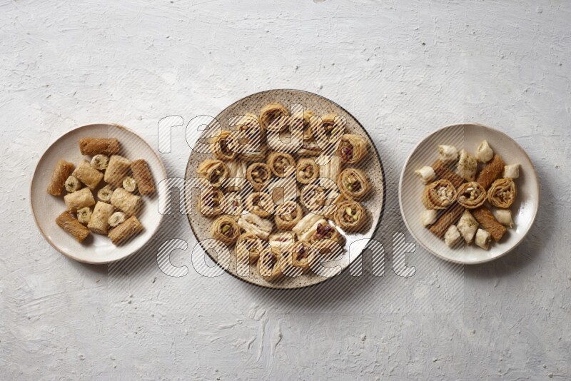 Oriental sweets in pottery plates in a light setup