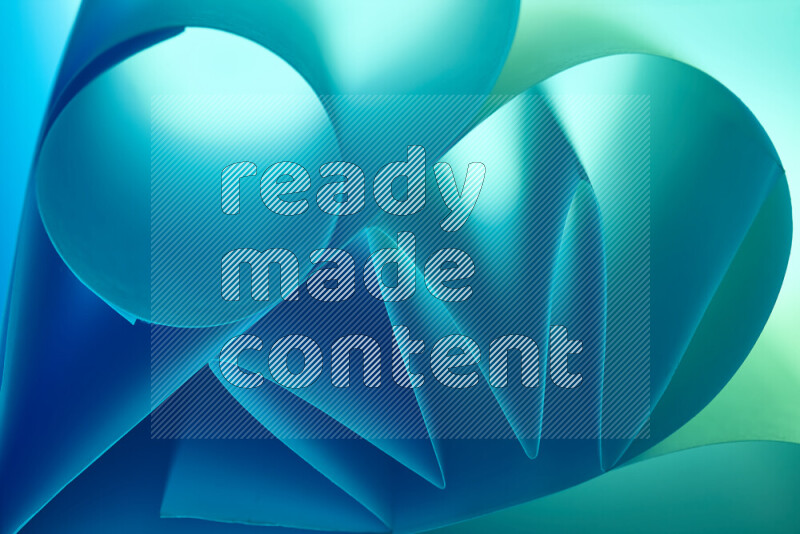 عرض فني لطيات الورق تخلق مزيج من الأشكال الهندسية، مضاءة بإضاءة ناعمة بدرجات اللون الأخضر والأزرق