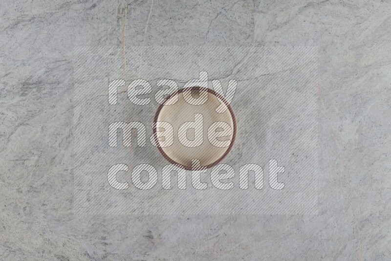 A multicolored pottery oven bowl on grey marble background