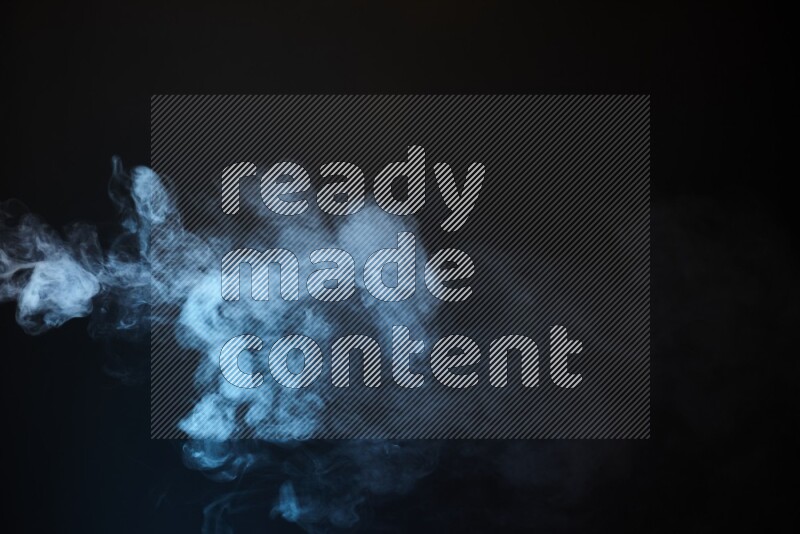 Heavy smoke in blue isolated on black background