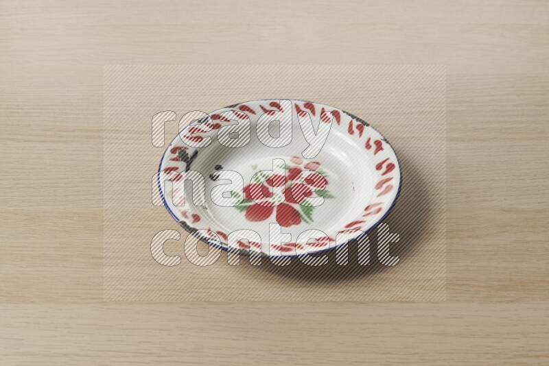 A vintage metal plate on light wooden background