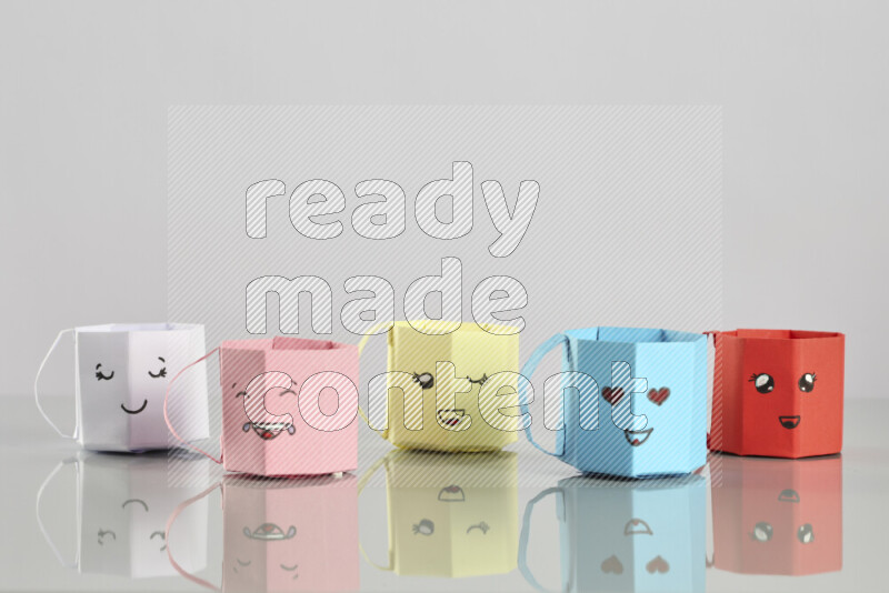 Origami cup on grey background