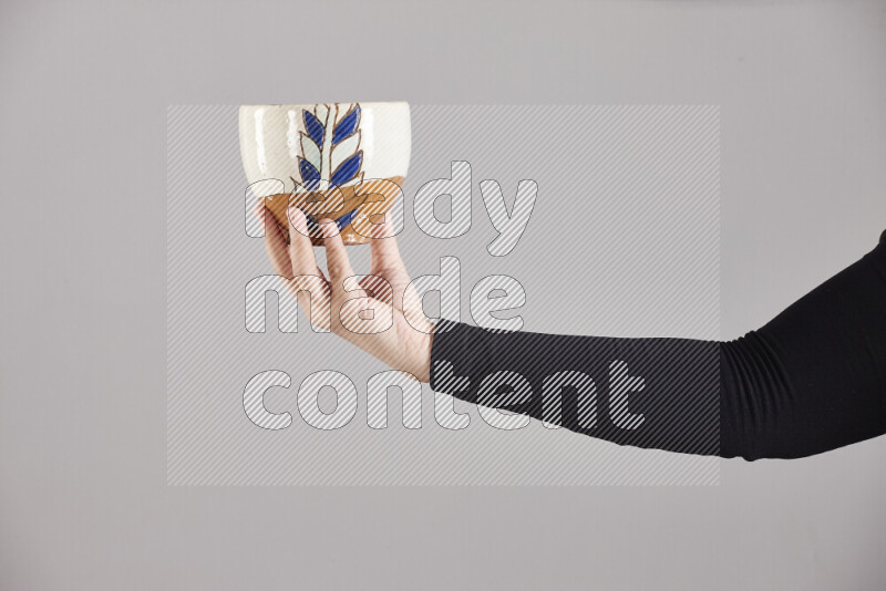 امرأة ترتدي عباءة سوداء تحمل أدوات فخارية مختلفة في أوضاع متعددة