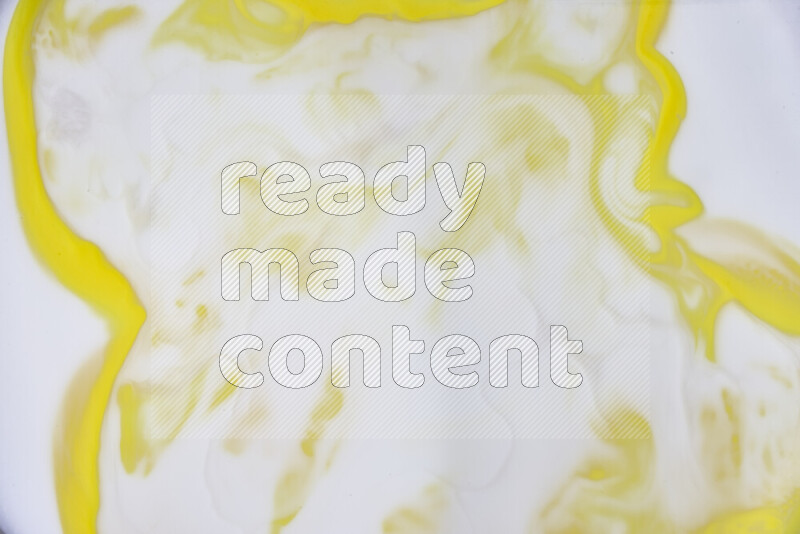 A close-up of abstract swirling patterns in yellow and white