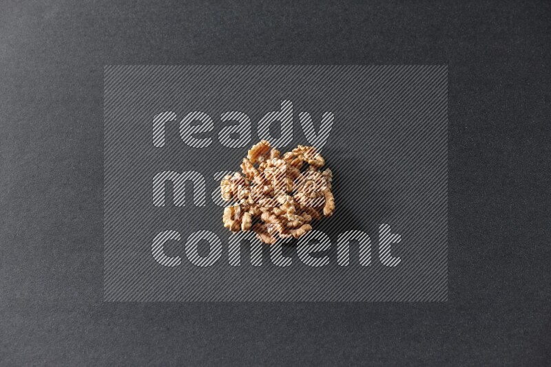 A bunch of walnuts on a black background in different angles