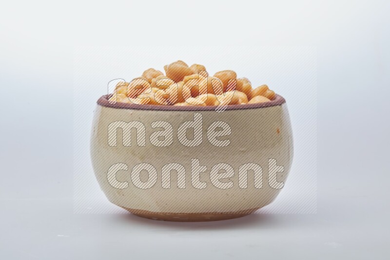 Close up shot of boiled chickpeas in a container on white background