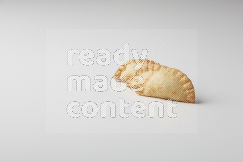 Three fried sambosas on a white background