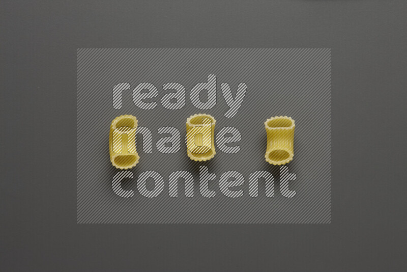 Elbow pasta on grey background