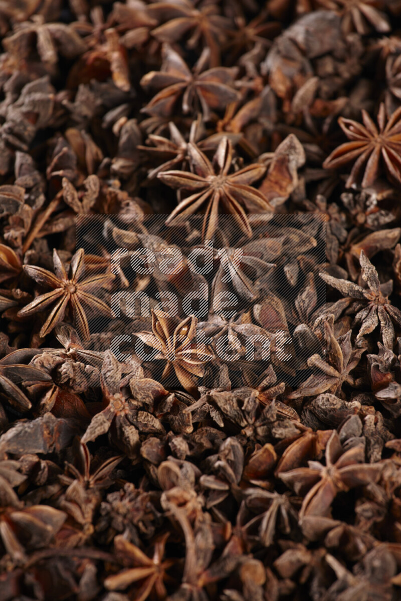 Star Anise fill the frame on black flooring