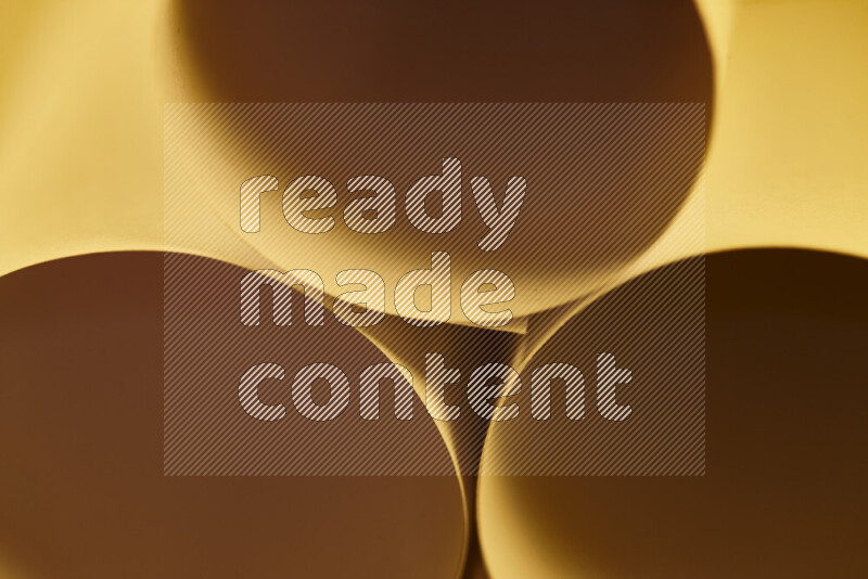 The image shows an abstract paper art with circular shapes in varying shades of orange