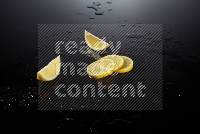 Lemon slices with water drops, and droplets on black background