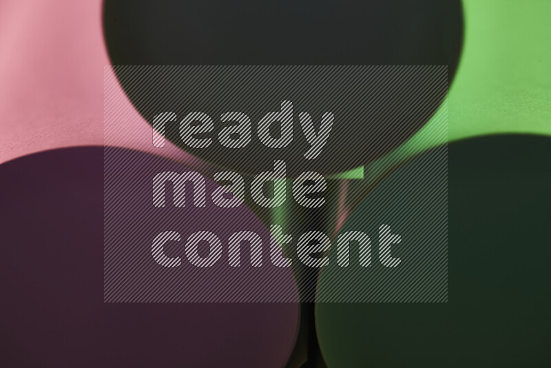 The image shows an abstract paper art with circular shapes in varying shades of green and pink