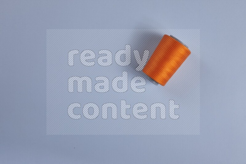 An orange collection of sewing and tailoring tools arranged on a blue background