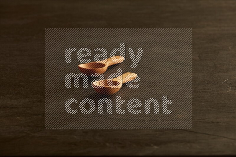 wooden spoon on black slate background