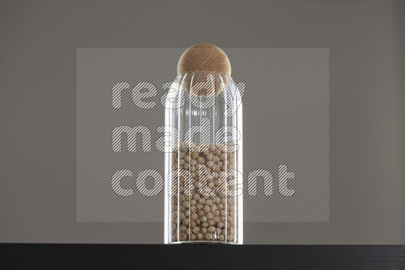 Chickpeas in a glass jar on black background