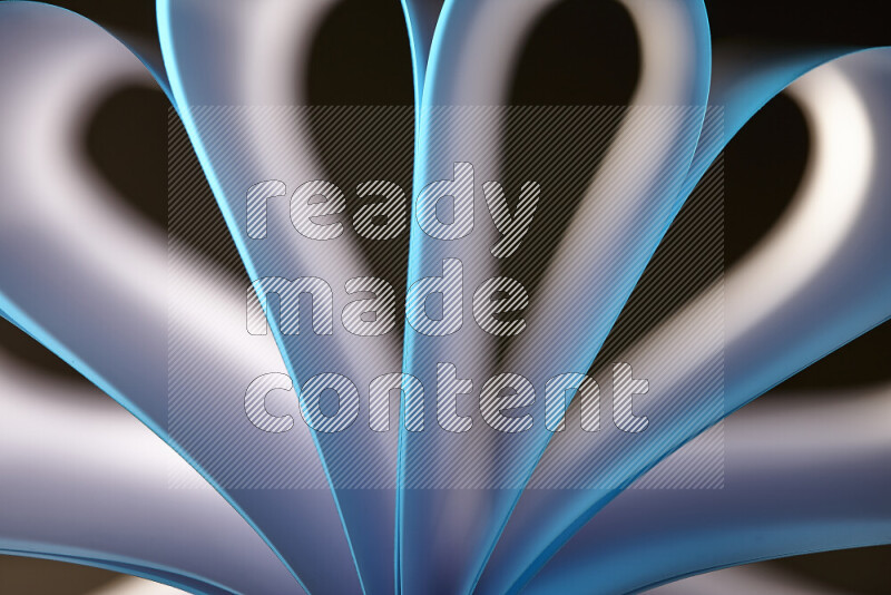 An abstract art piece displaying smooth curves in white and blue gradients created by colored light