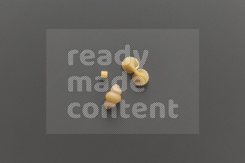 Different pasta types on grey background