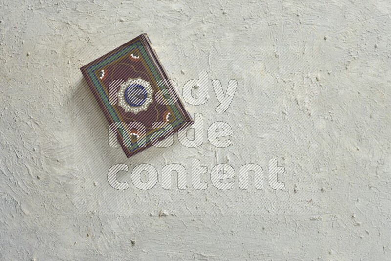 Quran with a prayer beads on white background