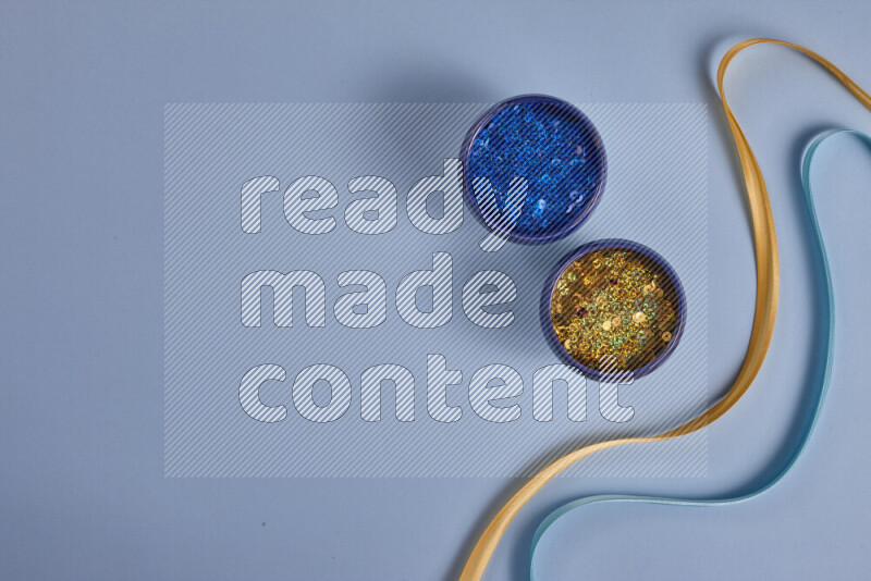 A yellow and blue collection of sewing and tailoring tools arranged on a blue background
