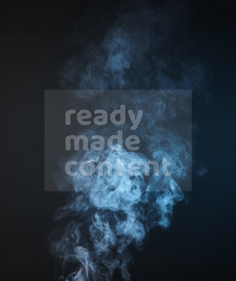 Heavy smoke in blue isolated on black background