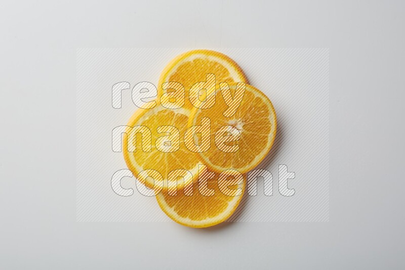 Four orange slices on a white background