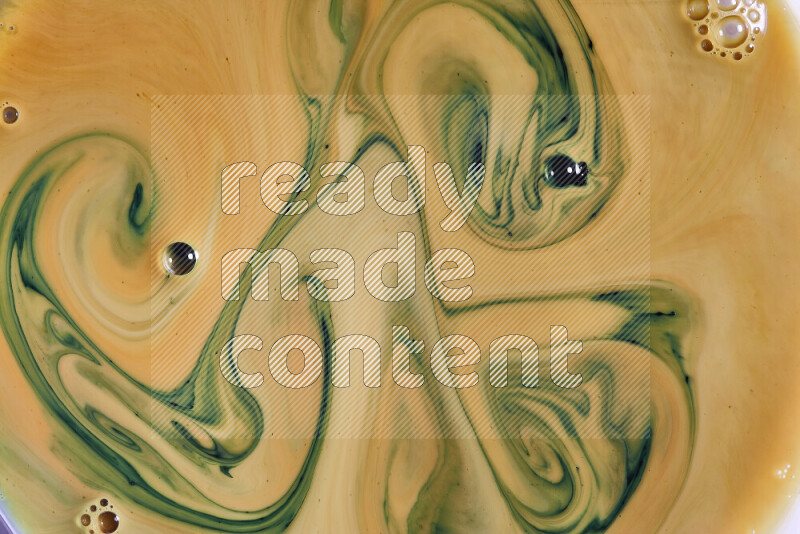 A close-up of abstract swirling patterns in orange and green