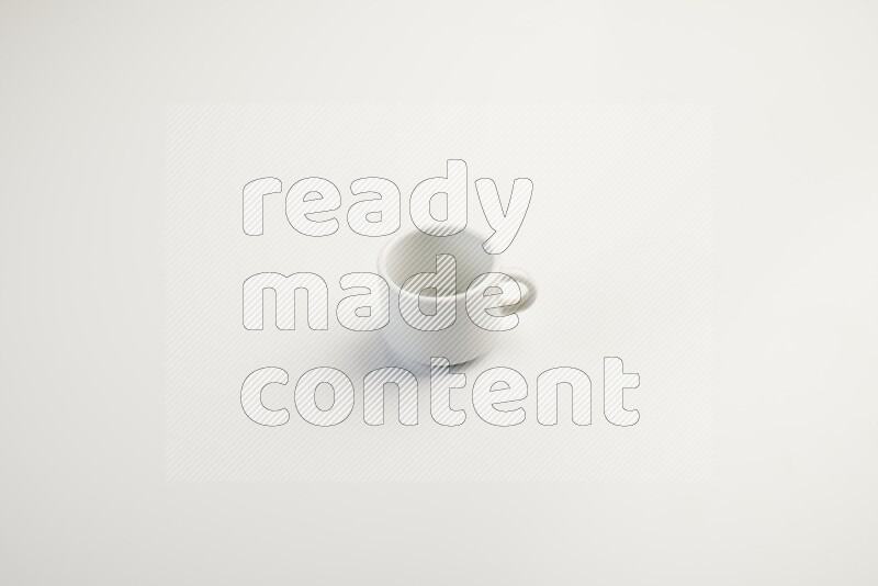 white ceramic cup on white countertop