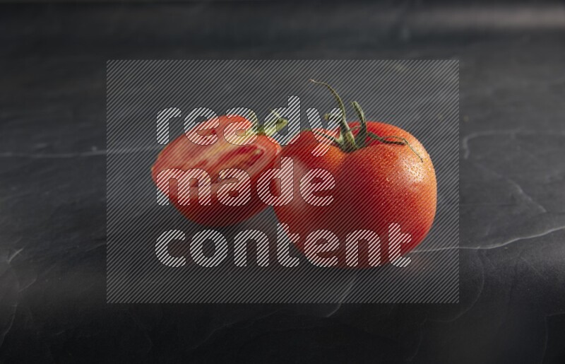 45 degree roma tomato on a textured black slate background