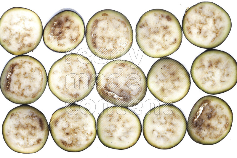 Eggplant slices on illuminated white background