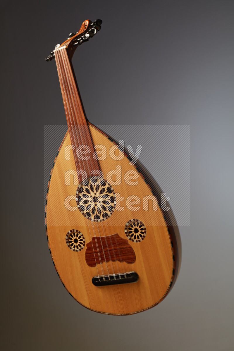 a wooden brown Oud on a gray background