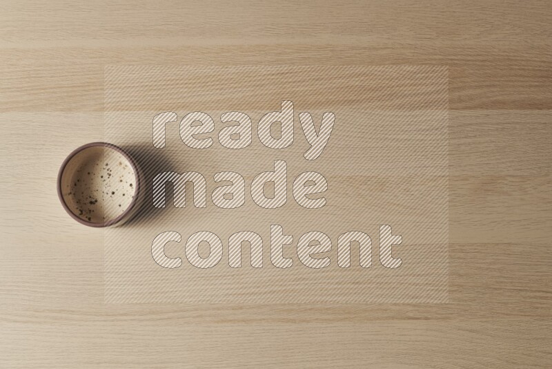 A multicolored pottery oven plate on light wooden background