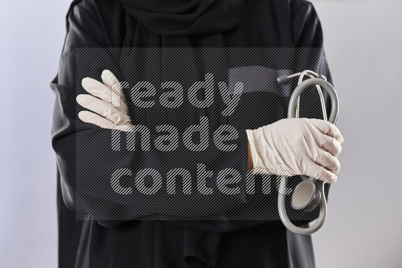 Female doctor wearing an abaya and medical attire in different positions