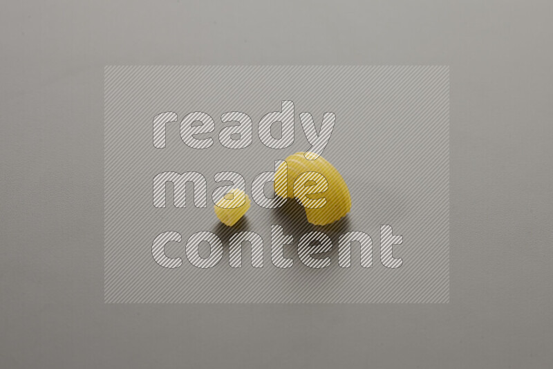 Small rings pasta with other types of pasta on grey background