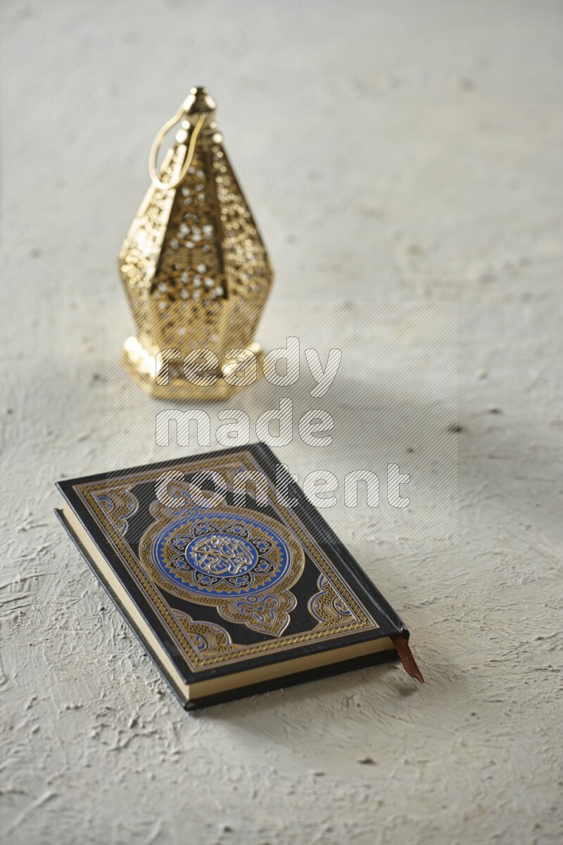 A golden lantern with different drinks, dates, nuts, prayer beads and quran on textured white background
