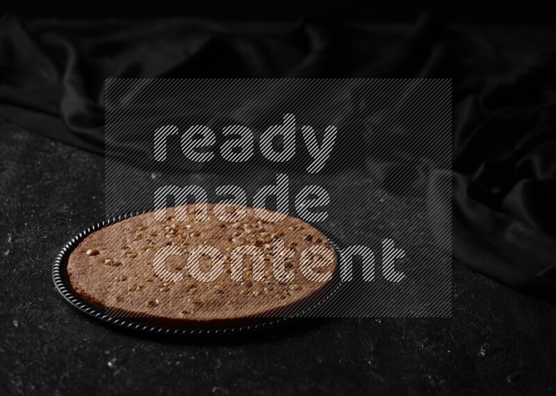 بسبوسة في أطباق مختلفه علي خلفية سوداء خشبية