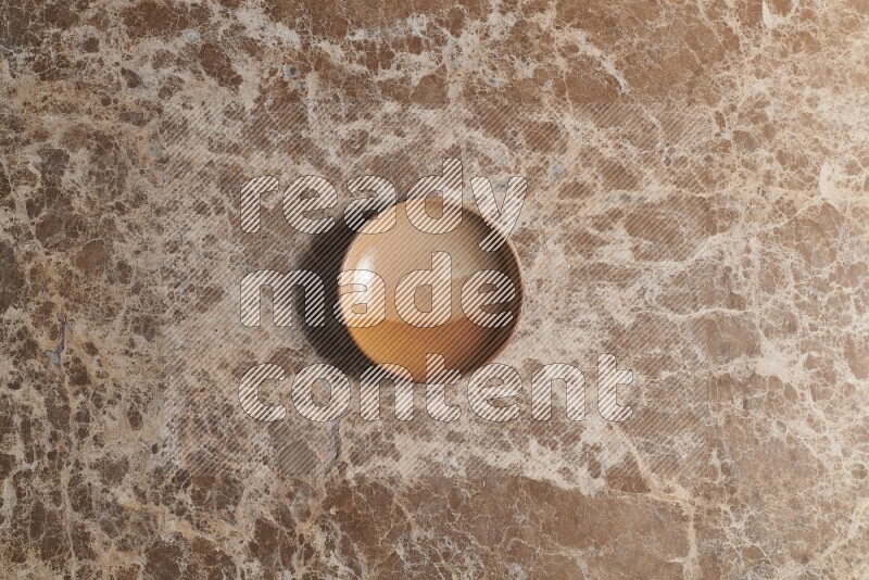 A multicolored pottery plate on beige marble background