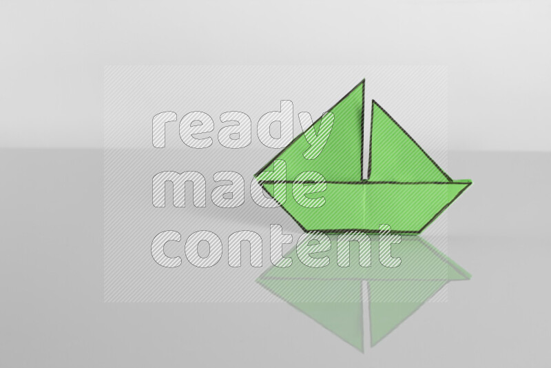 Origami boat on grey background