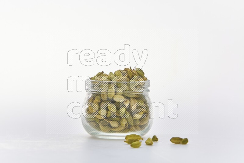 Cardamon in a container on white background