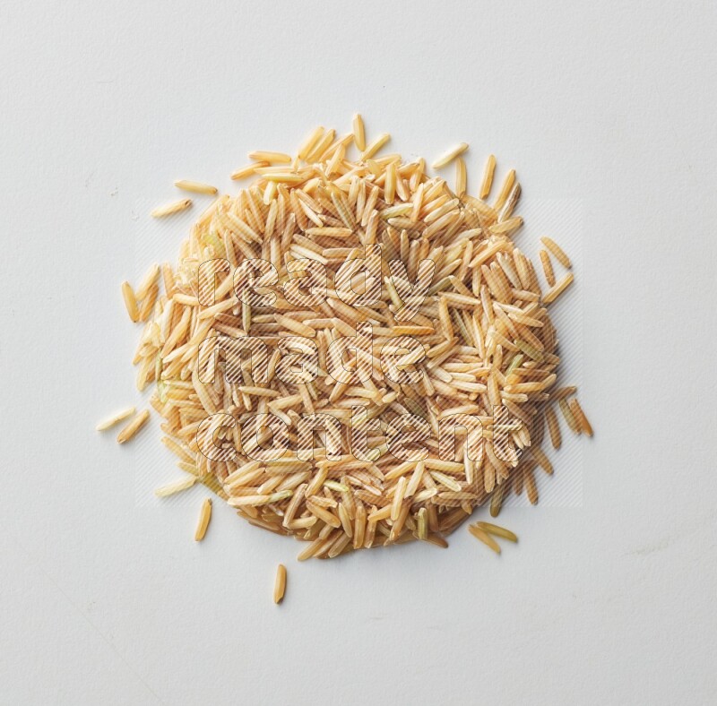 Top-view shot of long grain brown rice on white background