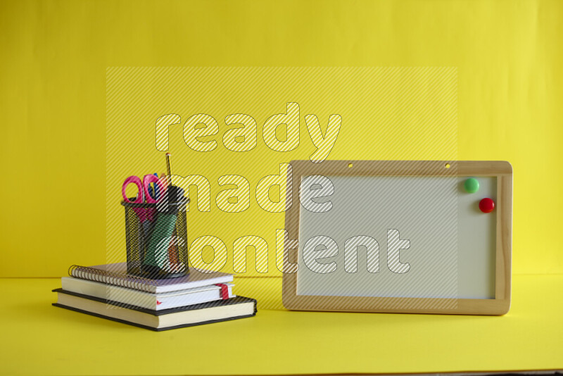 A whiteboard with different school supplies on yellow background