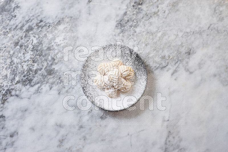 Kahk in black pottery plate on grey marble background