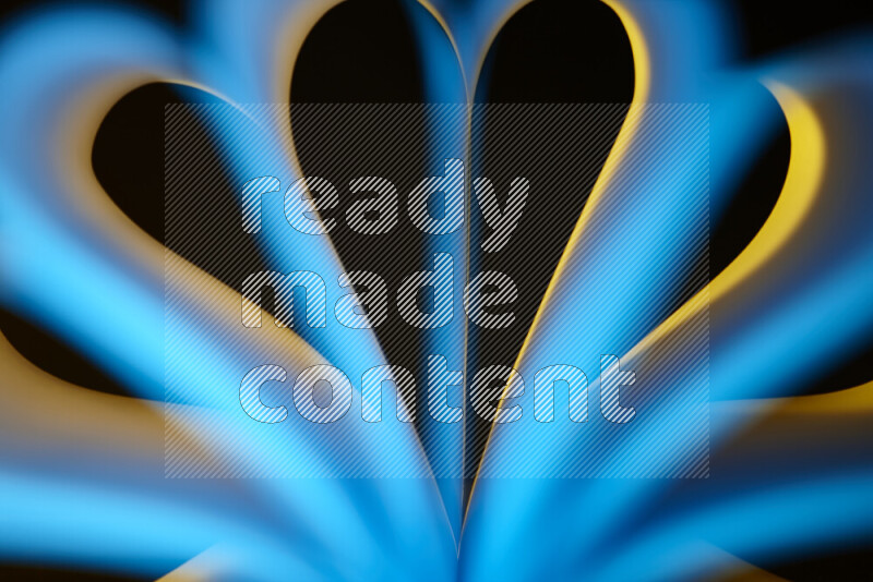 An abstract art piece displaying smooth curves in yellow and blue gradients created by colored light
