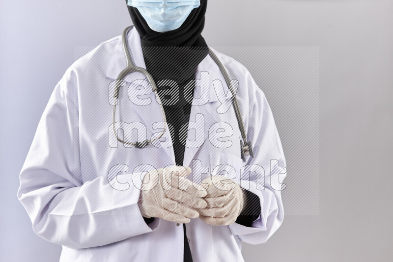Female doctor wearing an abaya and medical attire in different positions