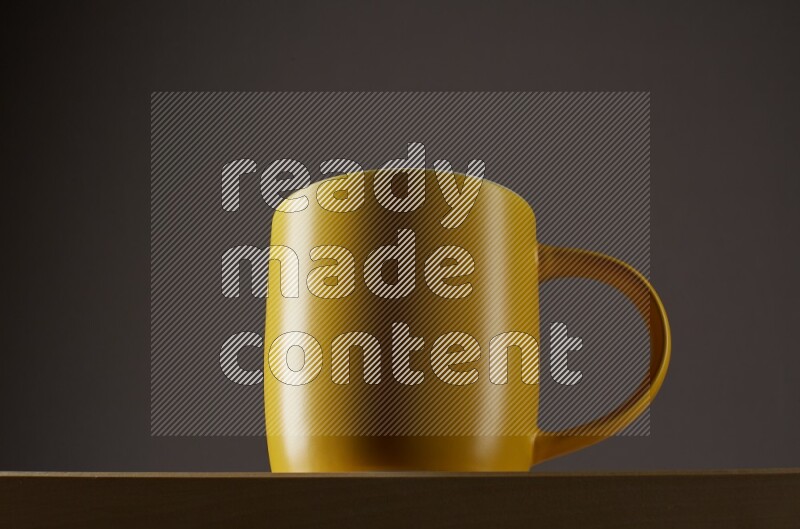 Low angle shot of a yellow cup on grey background